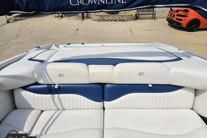 Slide: The Image of 2007 Crownline 23 SS boat interior with white and blue seating, outdoor setting. - 79