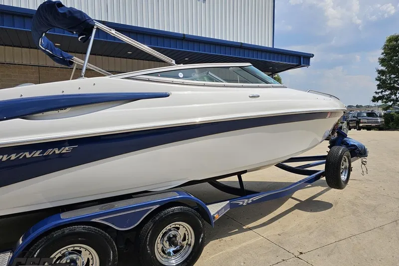 Slide: The Image of 2007 Crownline 23 SS boat on trailer, parked outdoors near a building. - 8