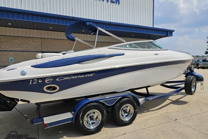 Slide: The Image of 2007 Crownline 23 SS boat on trailer, blue and white design, parked outdoors. - 9