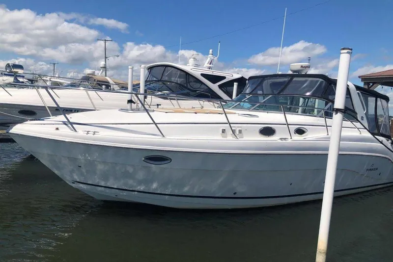 The Image of 2006 Rinker 342 Express Cruiser docked, featuring sleek design and spacious deck. - 0