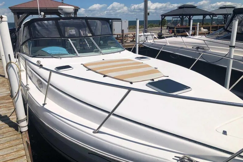 Slide: The Image of 2006 Rinker 342 Express Cruiser docked at marina under clear skies. - 1