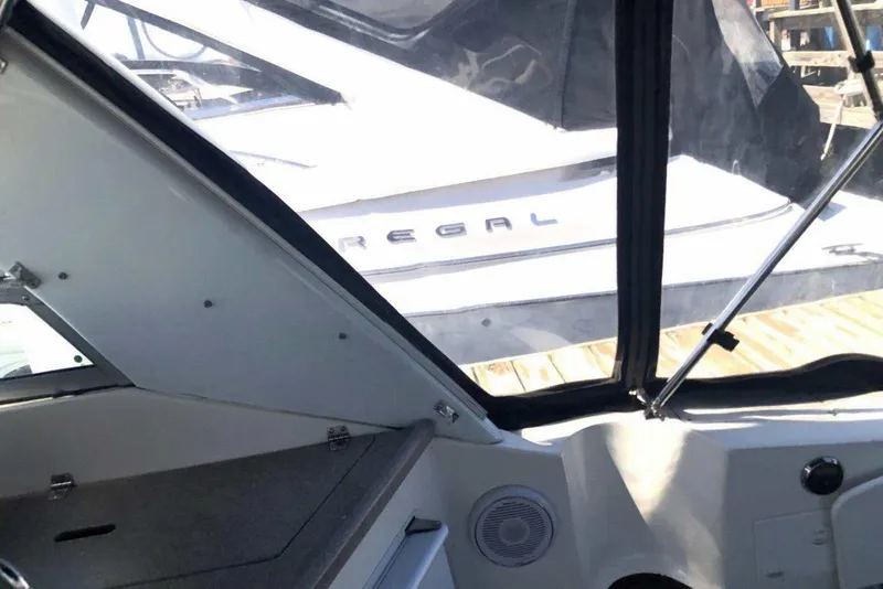 Slide: The Image of Interior view of a 2006 Rinker 342 Express Cruiser with a Regal boat outside. - 10