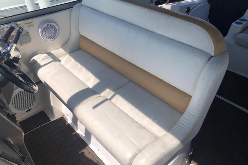 Slide: The Image of 2006 Rinker 342 Express Cruiser interior seating with steering wheel and speaker. - 14