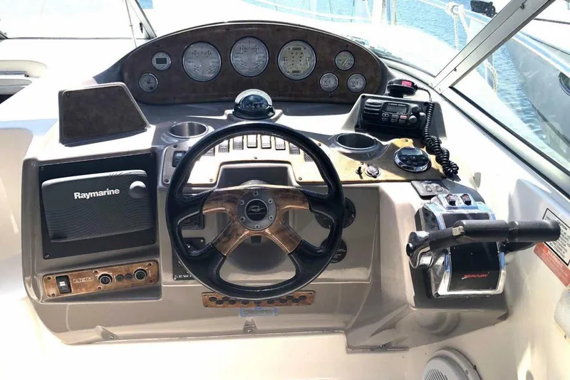 Slide: The Image of 2006 Rinker 342 Express Cruiser dashboard with steering wheel and navigation controls. - 16