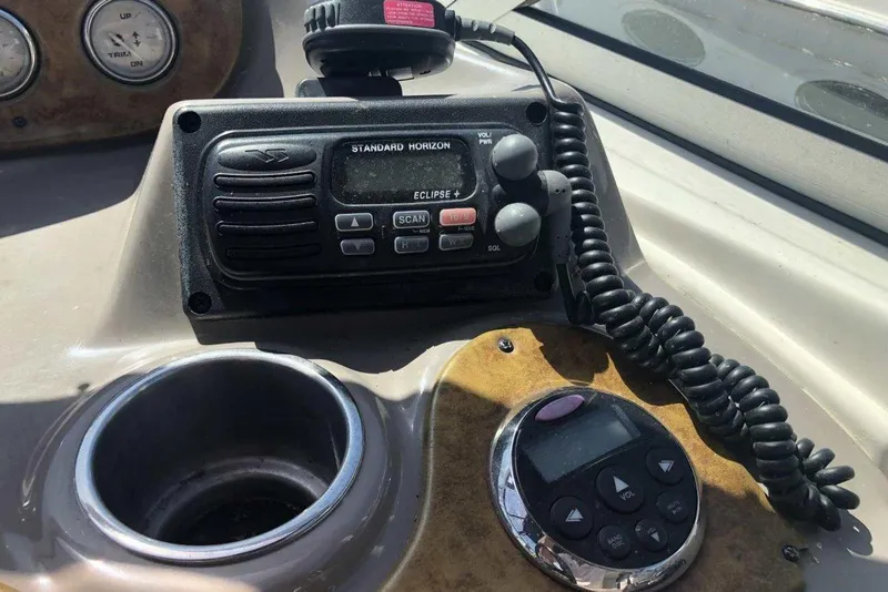 Slide: The Image of Control panel of a 2006 Rinker 342 Express Cruiser with radio and cup holder. - 17