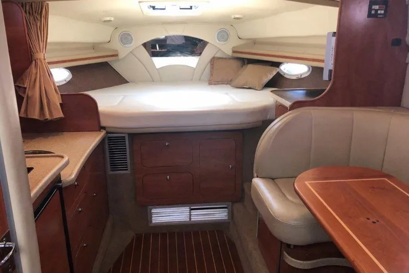 Slide: The Image of Interior of 2006 Rinker 342 Express Cruiser with cozy cabin and wooden furnishings. - 23