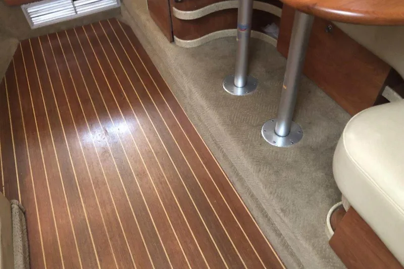 Slide: The Image of Interior of 2006 Rinker 342 Express Cruiser with wood flooring and table. - 28