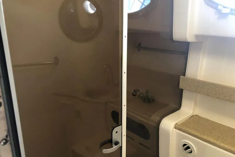 Slide: The Image of 2006 Rinker 342 Express Cruiser bathroom interior with sink and porthole window. - 34