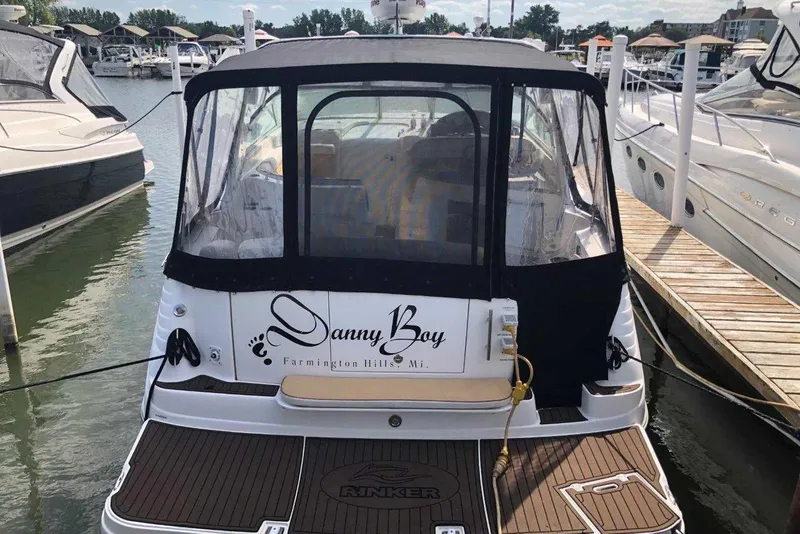 Slide: The Image of 2006 Rinker 342 Express Cruiser docked at marina, rear view with canopy. - 5