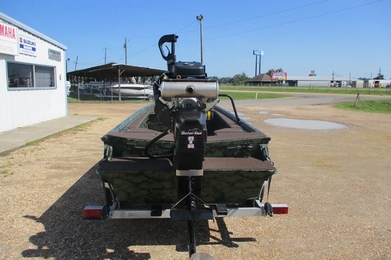 Slide: The Image of 2026 Gator Tail 1854 Extreme boat with motor, parked outdoors on gravel. - 4