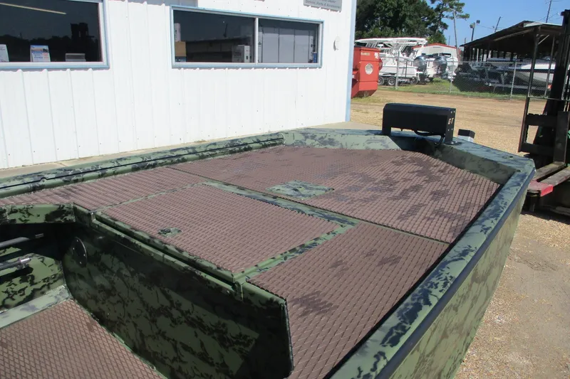 Slide: The Image of 2026 Gator Tail 1854 Extreme boat with camouflage design, parked outside a building. - 6