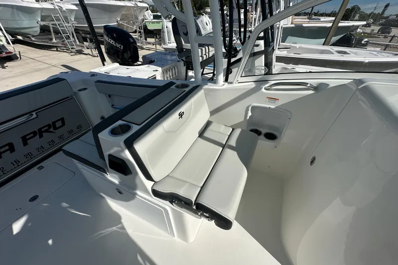 Slide: The Image of 2026 Sea Pro 240 Dual Console boat interior with seating and cup holders. - 12