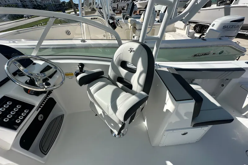 Slide: The Image of 2026 Sea Pro 240 Dual Console boat interior with steering wheel and seating. - 13