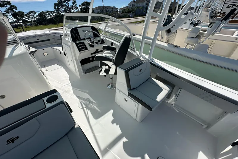 Slide: The Image of 2026 Sea Pro 240 Dual Console boat interior with steering wheel and seating. - 15