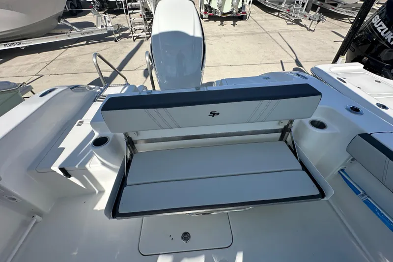 Slide: The Image of 2026 Sea Pro 240 Dual Console boat interior with foldable seating and cup holders. - 16