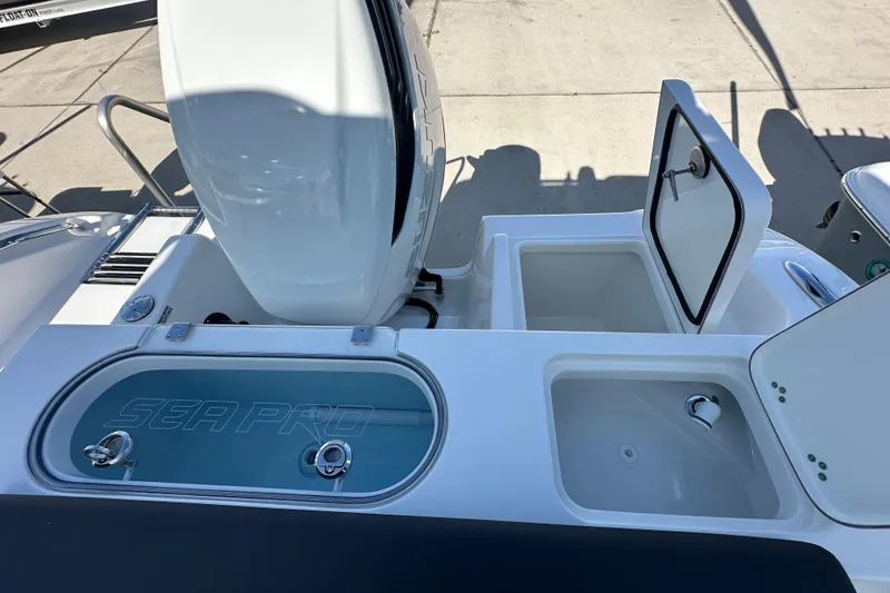 Slide: The Image of 2026 Sea Pro 240 Dual Console boat deck with storage compartments and livewell. - 17