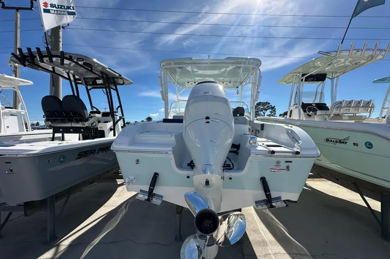 Slide: The Image of 2026 Sea Pro 240 Dual Console boat with Suzuki Marine engine, displayed outdoors. - 3