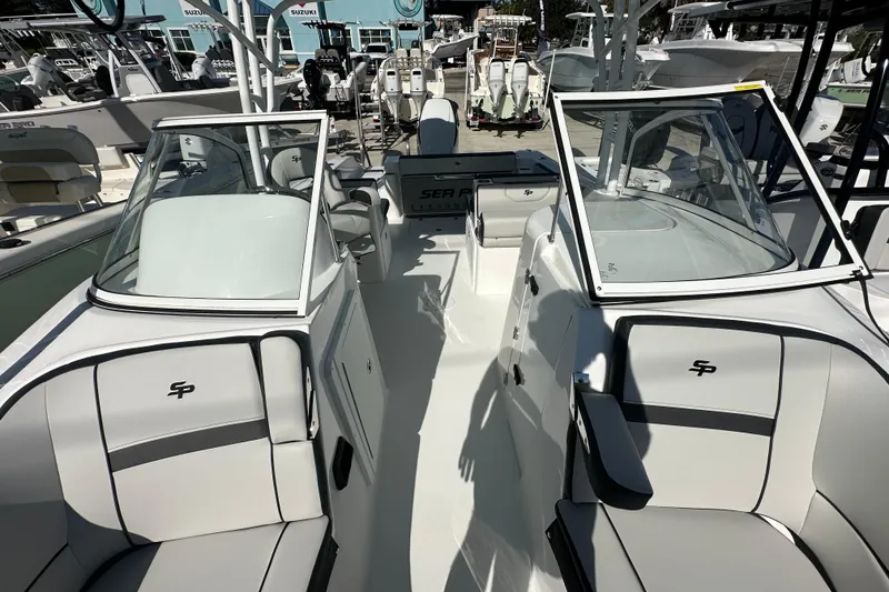 Slide: The Image of 2026 Sea Pro 240 Dual Console boat interior with seating and windshield. - 6