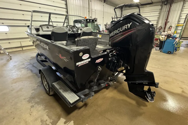 Slide: The Image of 2017 Tracker Pro Guide V-175 Combo boat with Mercury engine in a garage. - 4