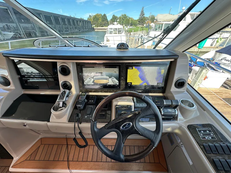 Slide: The Image of Helm of 2009 Sea Ray 60 Sundancer with navigation screens and controls. - 11