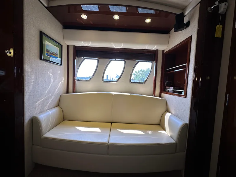 Slide: The Image of Luxurious interior of 2009 Sea Ray 60 Sundancer yacht with cream sofa and porthole windows. - 24