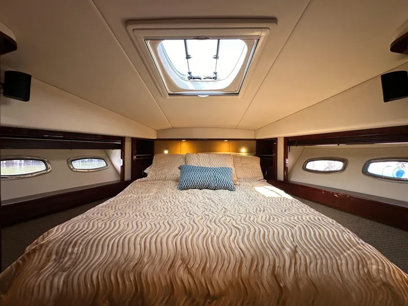 Slide: The Image of Luxurious 2009 Sea Ray 60 Sundancer cabin with skylight and elegant bedding. - 28