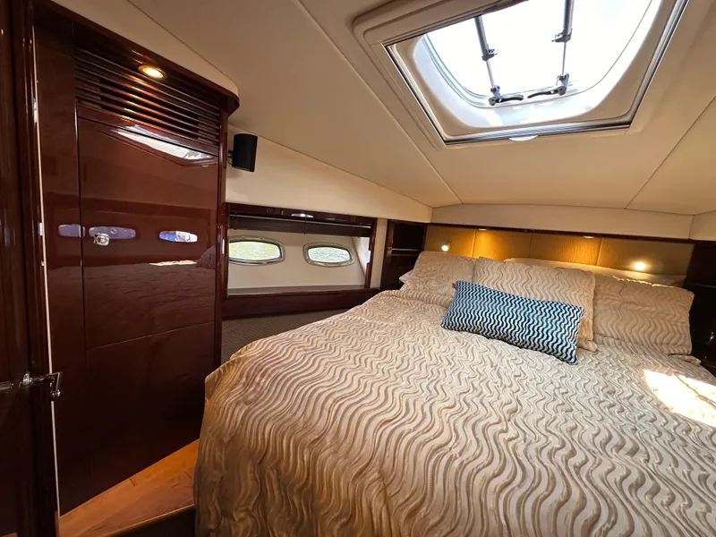 Slide: The Image of Luxurious cabin interior of 2009 Sea Ray 60 Sundancer yacht with skylight and plush bedding. - 29