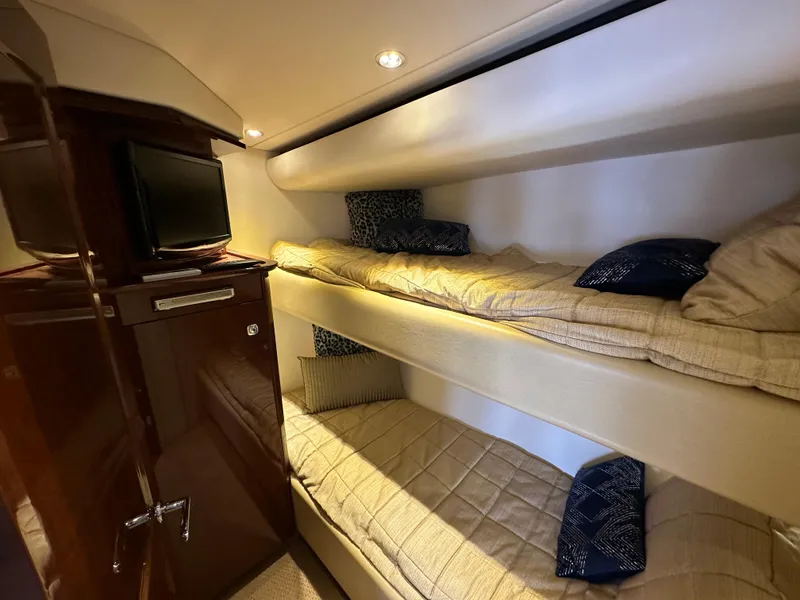 Slide: The Image of Interior of 2009 Sea Ray 60 Sundancer with cozy bunk beds and a TV. - 33