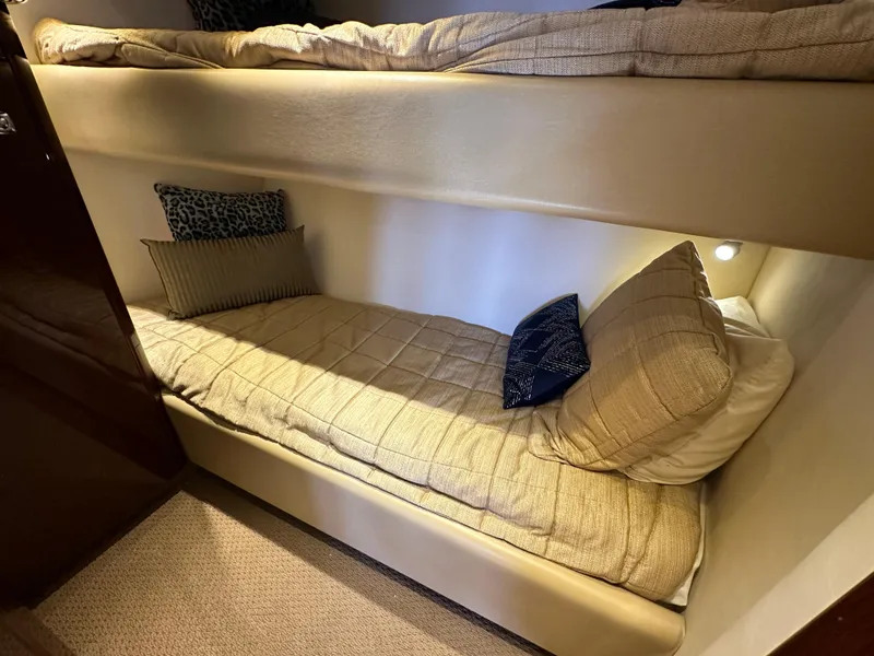 Slide: The Image of Bunk beds in 2009 Sea Ray 60 Sundancer yacht cabin, featuring cozy bedding and cushions. - 34
