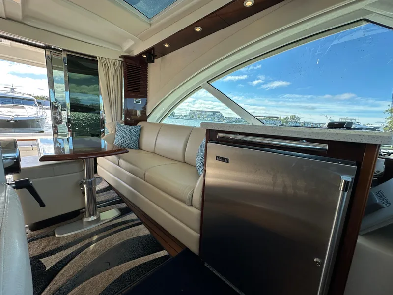 Slide: The Image of Luxurious interior of 2009 Sea Ray 60 Sundancer yacht with sofa and mini fridge. - 8