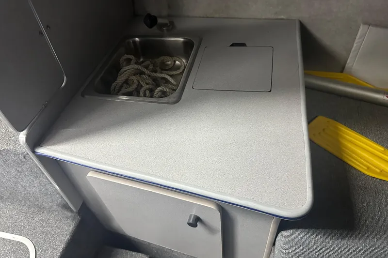 Slide: The Image of 1992 Bayliner 2252 Ciera Classic interior with sink and storage area. - 11