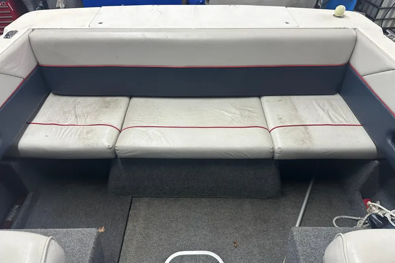Slide: The Image of Interior seating of 1992 Bayliner 2252 Ciera Classic boat, featuring white and gray upholstery. - 13