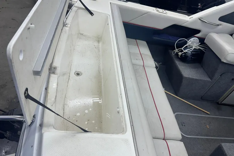 Slide: The Image of 1992 Bayliner 2252 Ciera Classic boat interior with open storage compartment. - 3