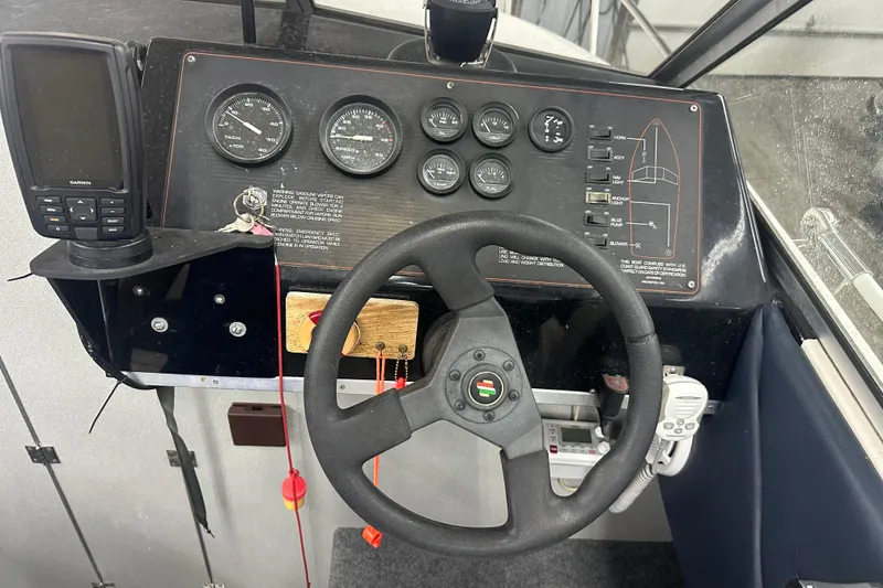 Slide: The Image of 1992 Bayliner 2252 Ciera Classic dashboard with steering wheel and navigation instruments. - 4
