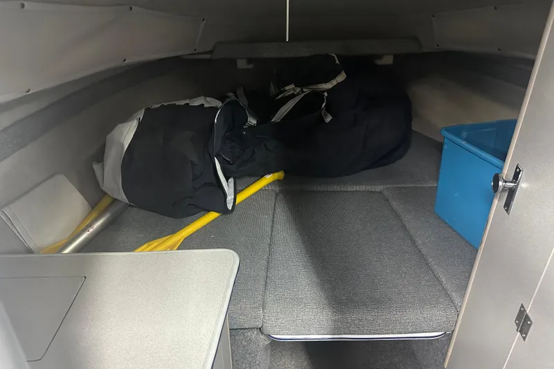 Slide: The Image of Interior cabin of a 1992 Bayliner 2252 Ciera Classic with storage items and blue container. - 5