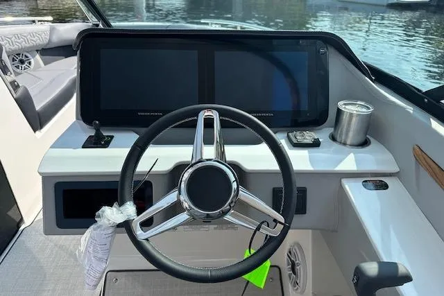 Slide: The Image of 2026 Regal LS9 boat dashboard with steering wheel and dual screens. - 3