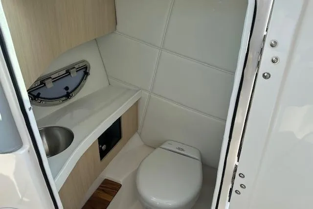 Slide: The Image of Compact bathroom in 2026 Regal LS9 boat with toilet and sink. - 5