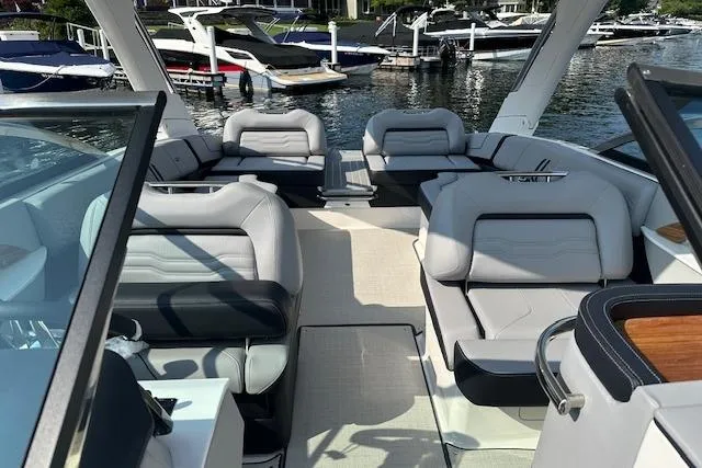 Slide: The Image of Luxurious 2026 Regal LS9 boat interior with plush seating, docked at a marina. - 8