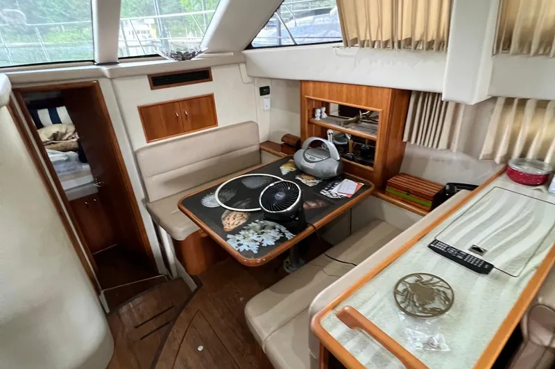 Slide: The Image of Interior of 2005 Carver 33 Super Sport with beige sofa and decorative pillows. - 11