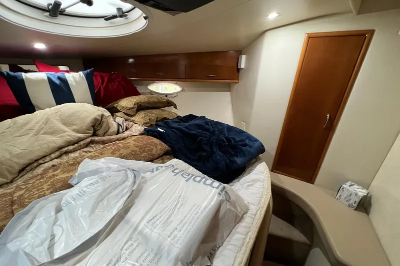 Slide: The Image of Cozy cabin interior of 2005 Carver 33 Super Sport with bedding and storage. - 18