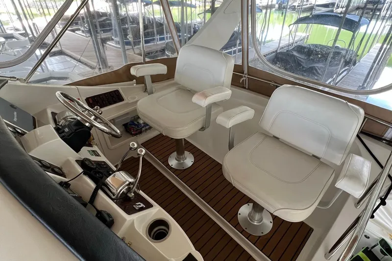 Slide: The Image of 2005 Carver 33 Super Sport yacht docked in a covered marina. - 2