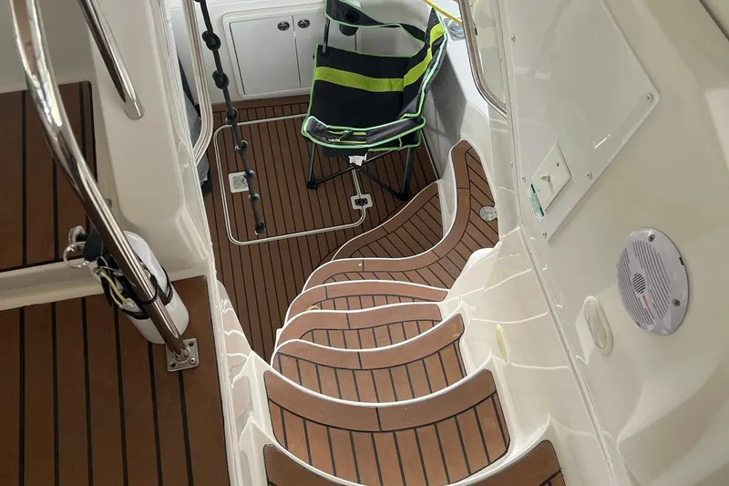 Slide: The Image of 2005 Carver 33 Super Sport yacht interior with white seating and red blanket. - 5