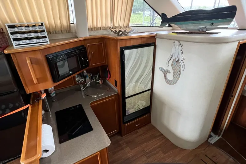 Slide: The Image of 2005 Carver 33 Super Sport yacht with elegant wooden deck and curved stairs. - 9