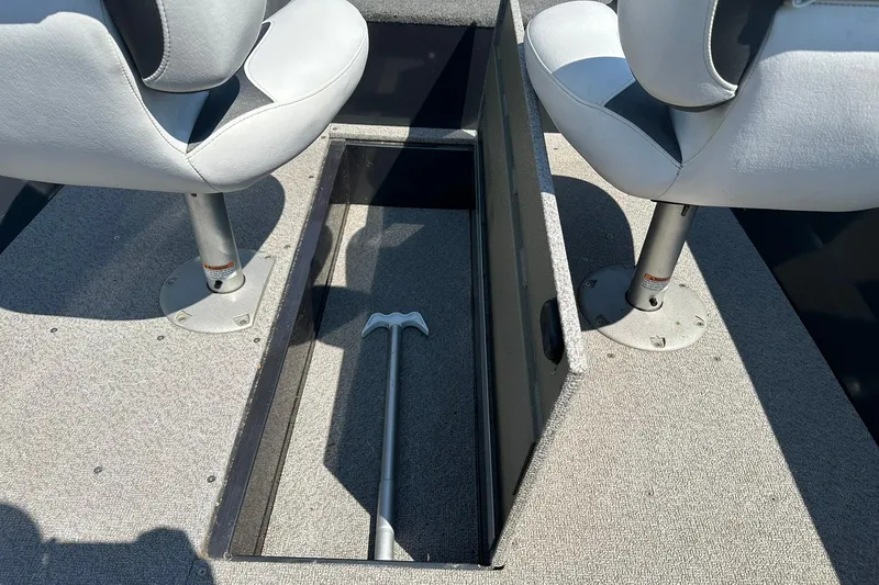 Slide: The Image of 2013 Crestliner 16 Kodiak boat interior with storage compartment and two seats. - 16