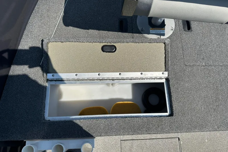 Slide: The Image of 2013 Crestliner 16 Kodiak boat storage compartment with open lid, revealing interior space. - 17