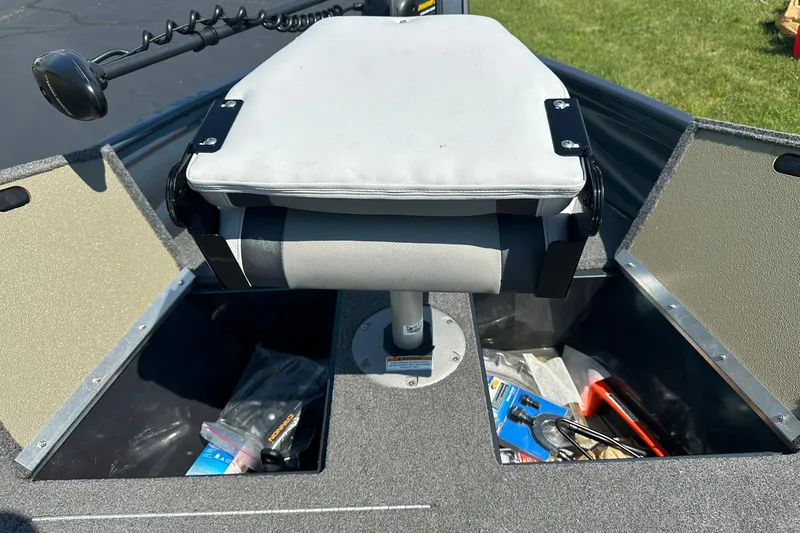 Slide: The Image of 2013 Crestliner 16 Kodiak boat interior with storage compartments and cushioned seat. - 18
