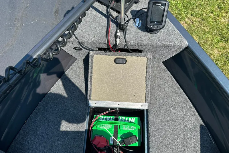 Slide: The Image of 2013 Crestliner 16 Kodiak boat interior with battery and fish finder. - 19