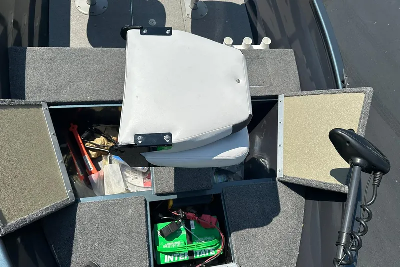 Slide: The Image of 2013 Crestliner 16 Kodiak boat interior with storage compartments and seating. - 20