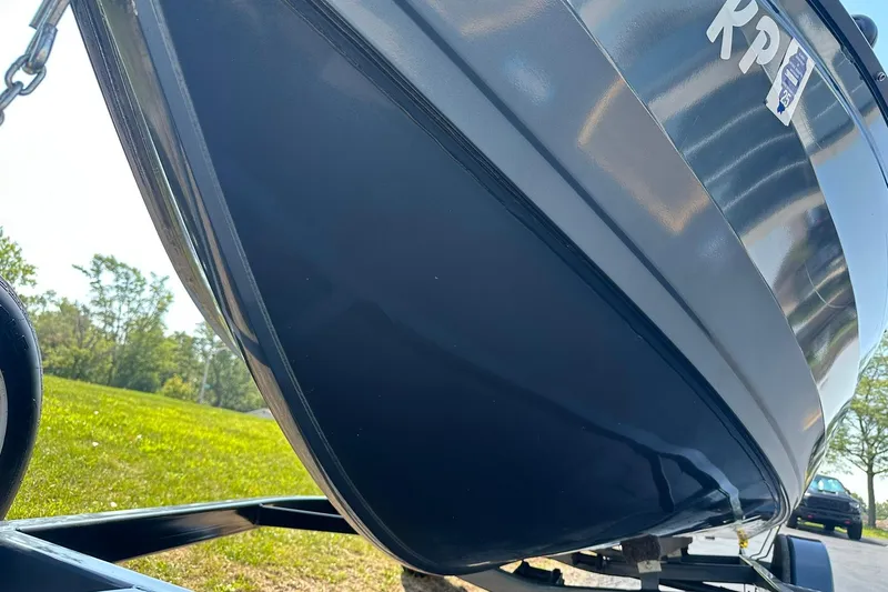 Slide: The Image of 2013 Crestliner 16 Kodiak boat on trailer, close-up view, outdoors. - 28