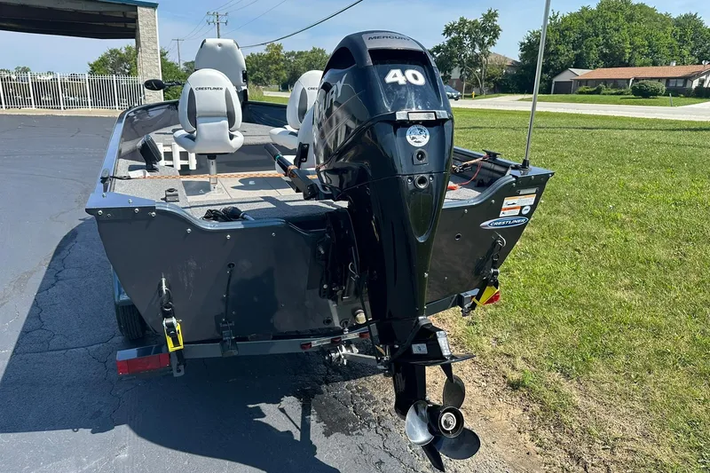 Slide: The Image of 2013 Crestliner 16 Kodiak boat with Mercury 40 outboard motor, parked on pavement. - 3